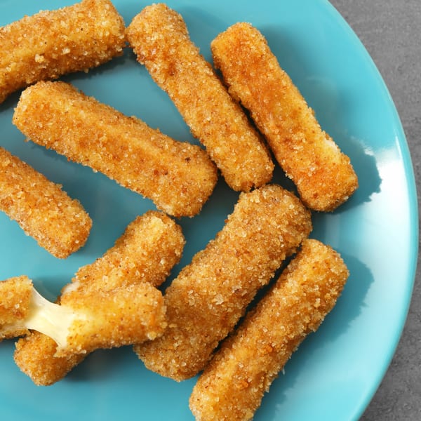 Golden-brown mozzarella sticks, one broken with melted cheese stretching, on a blue plate.